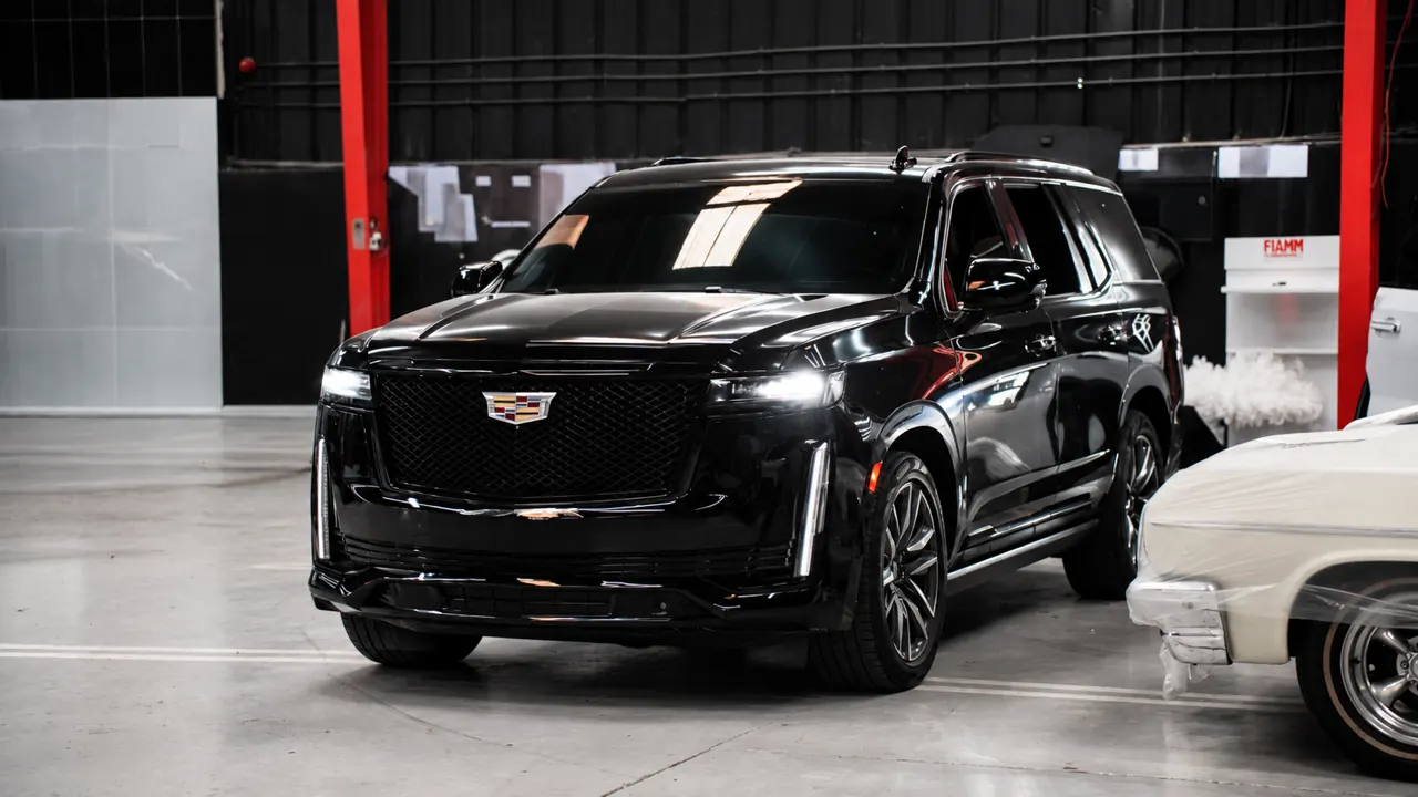 A Cadillac Escalade in the bay at Al Zaabi Autocare, Mussafah