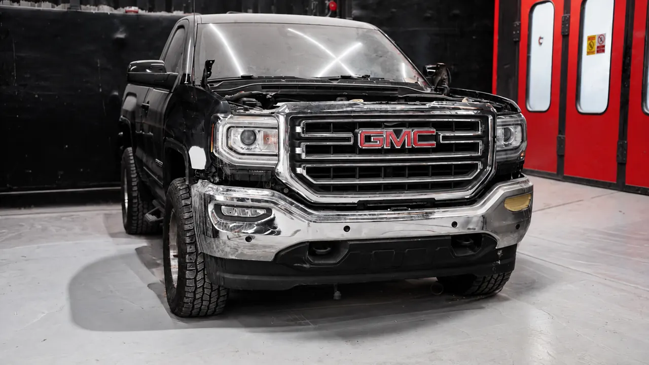 A GMC Sierra in for repair in the bay at Al Zaabi Autocare, Mussafah