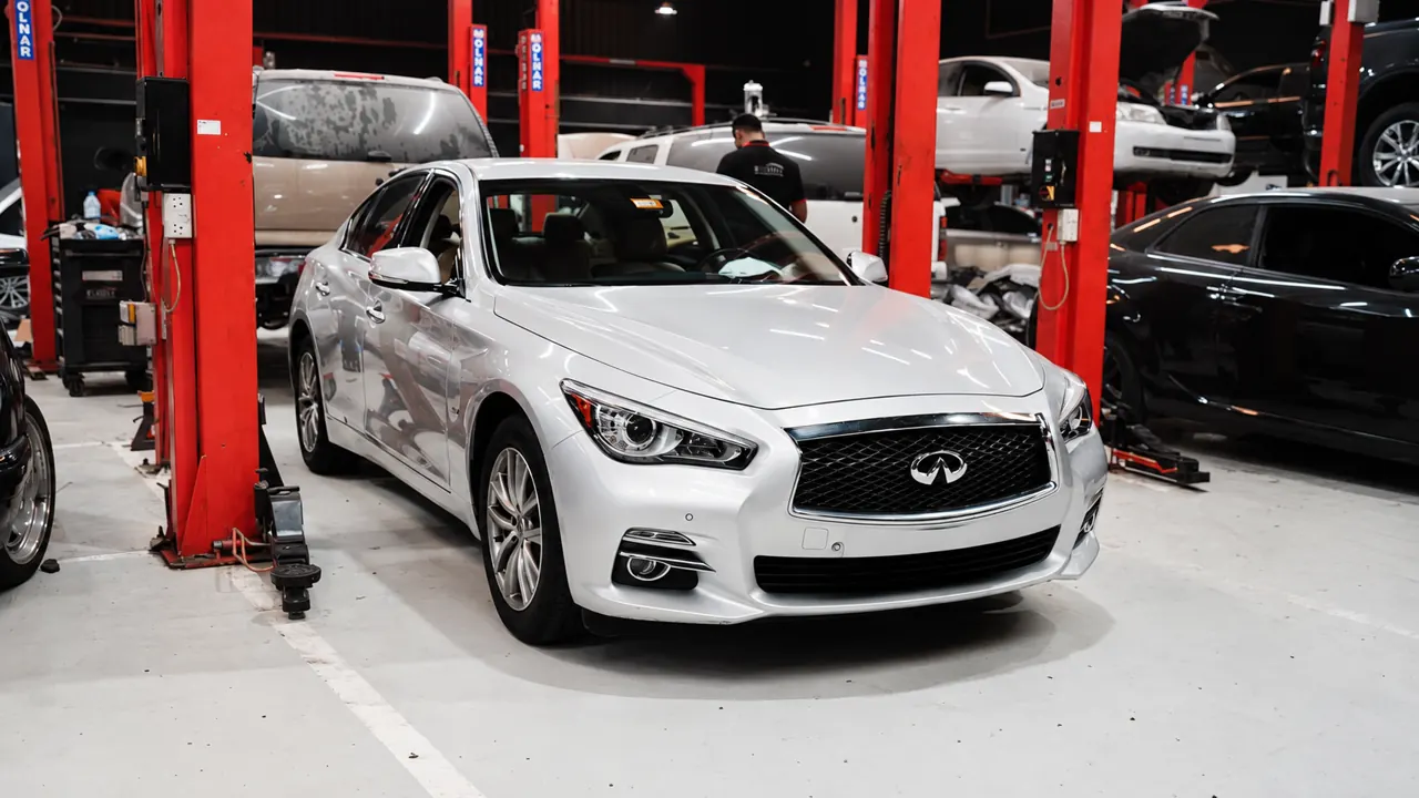 An Infiniti Q50 in the bay at Al Zaabi Autocare, Mussafah