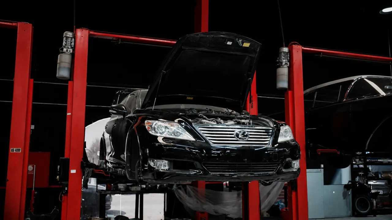 A Lexus LS raised on a lift in the bay at Al Zaabi Autocare, Mussafah