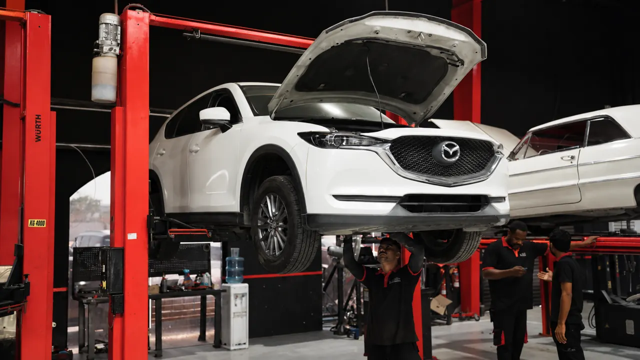A Mazda CX-5 raised on a lift in the bay at Al Zaabi Autocare, Mussafah