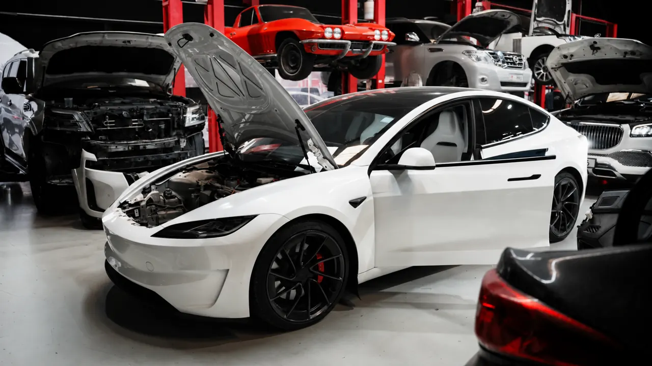 A Tesla Model 3 with the bonnet up in the bay at Al Zaabi Autocare, Mussafah