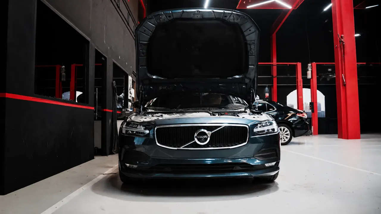 A Volvo S90 with the bonnet up in the bay at Al Zaabi Autocare, Mussafah